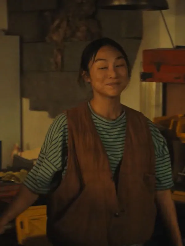Greta Lee wearing The Last House 2026 Quilted Vest in a workshop. The Last House 2026 Greta Lee Quilted Vest