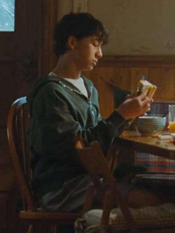 Noah Alexander Sosnowski sitting at table wearing The Last House Green Hooded Jacket. The Last House Movie Noah Alexander Sosnowski Hooded Jacket