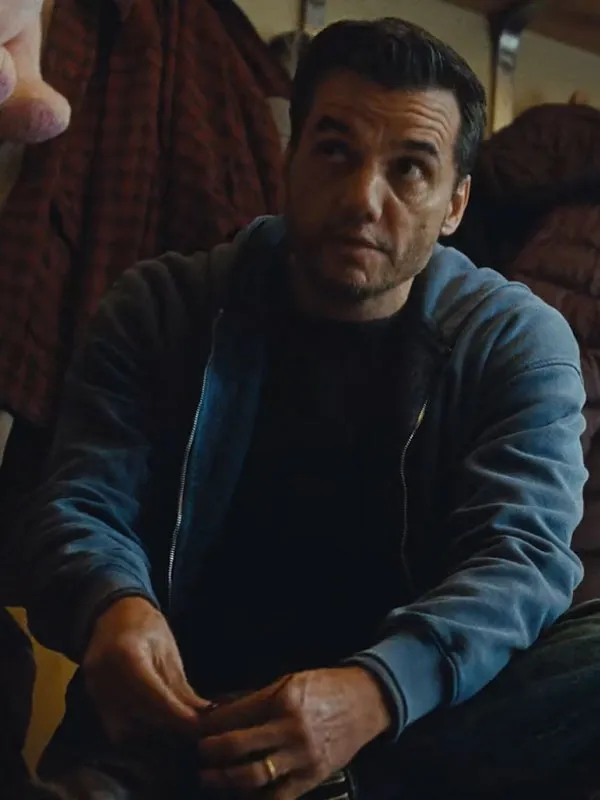 Wagner Moura wearing The Last House Slate Blue Fleece Jacket seated. The Last House Movie Wagner Moura Fleece Jacket