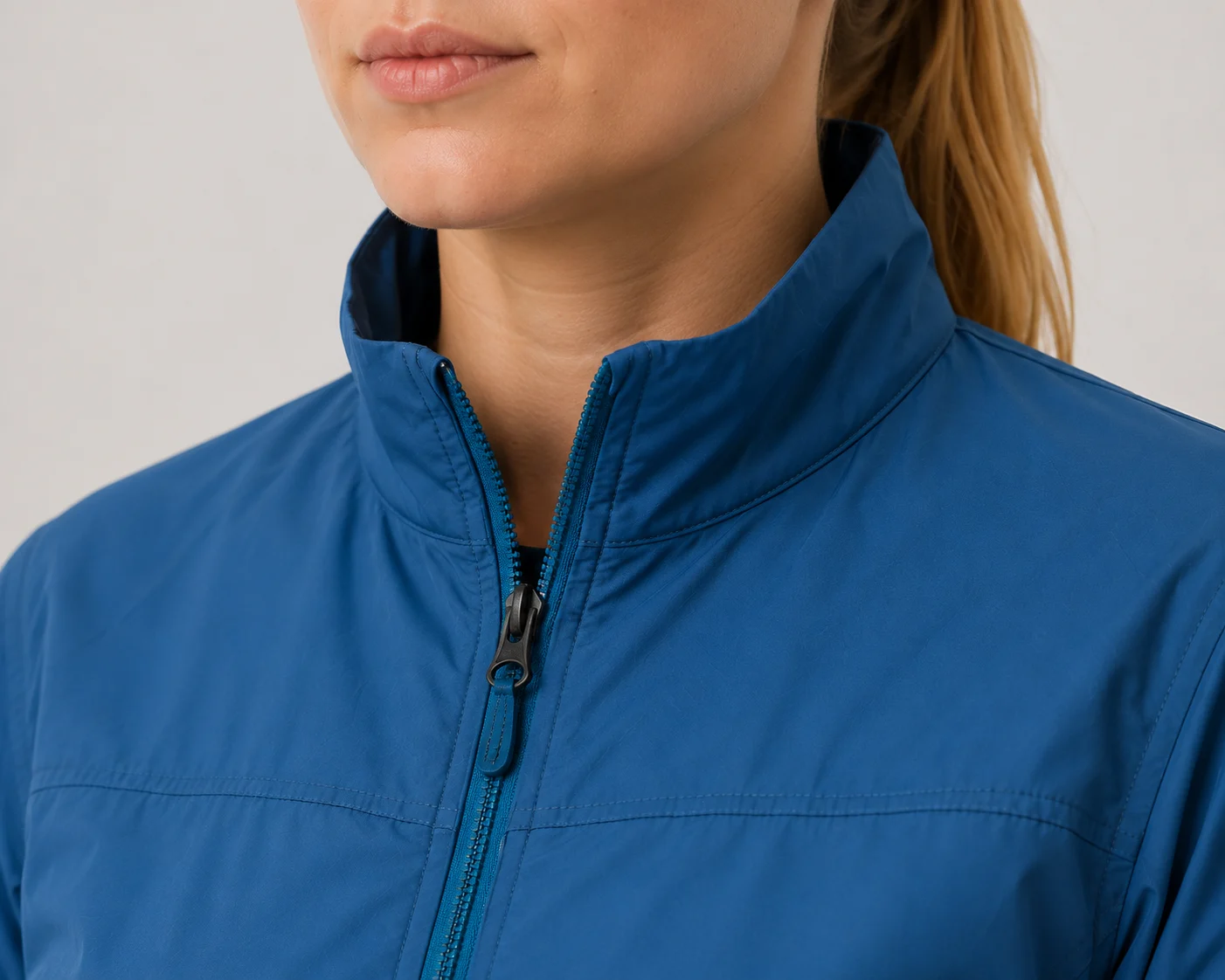 Close up of stand collar and blue YKK zipper on Becky Connor jacket