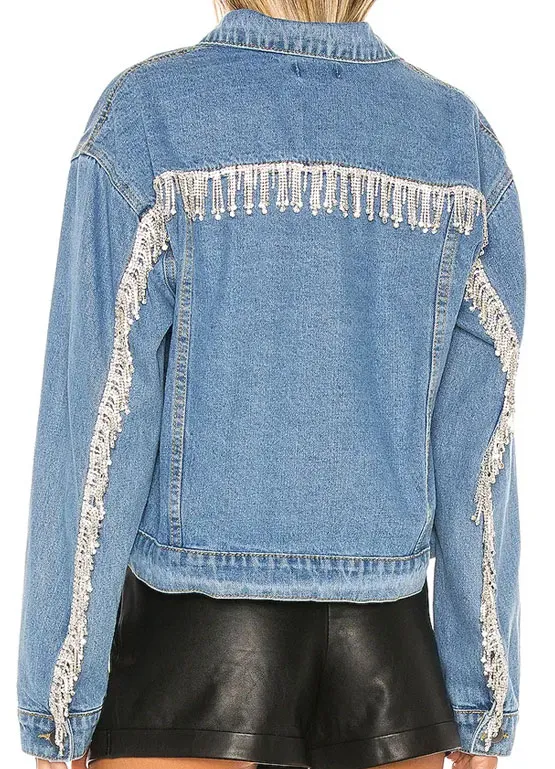 Back view of the light blue denim jacket featuring sparkling crystal fringe trim along the back and sleeves