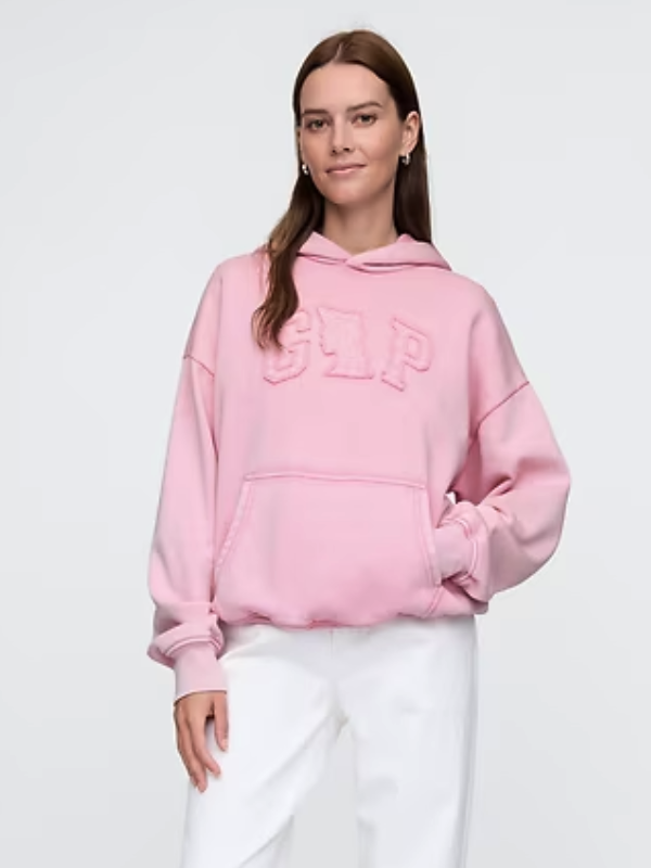Front view of model wearing the Wicked Pink Logo Hoodie with hand in kangaroo pocket