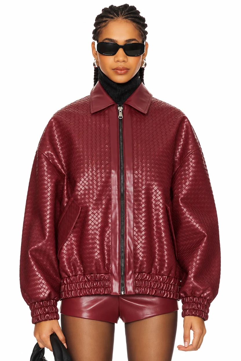 Front view of a model wearing the women's Kenny burgundy woven faux leather bomber jacket with sunglasses, zip front, and shirt collar. Women’s Kenny Burgundy Faux Leather Bomber Jacket