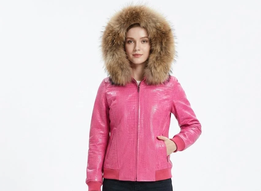 Front view of a woman wearing the hot pink crocodile-embossed leather bomber jacket featuring a plush brown faux fur collar hood and zip pockets. Women’s Pink Crocodile Hooded Fur Collar Leather Bomber Jacket