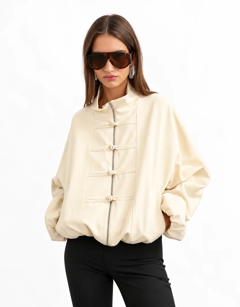 Front view of a model wearing the off-white cream Topshop mandarin collar leather bomber jacket with braided frog knots and sunglasses. Women’s Topshop Mandarin Collar Leather Bomber Jacket