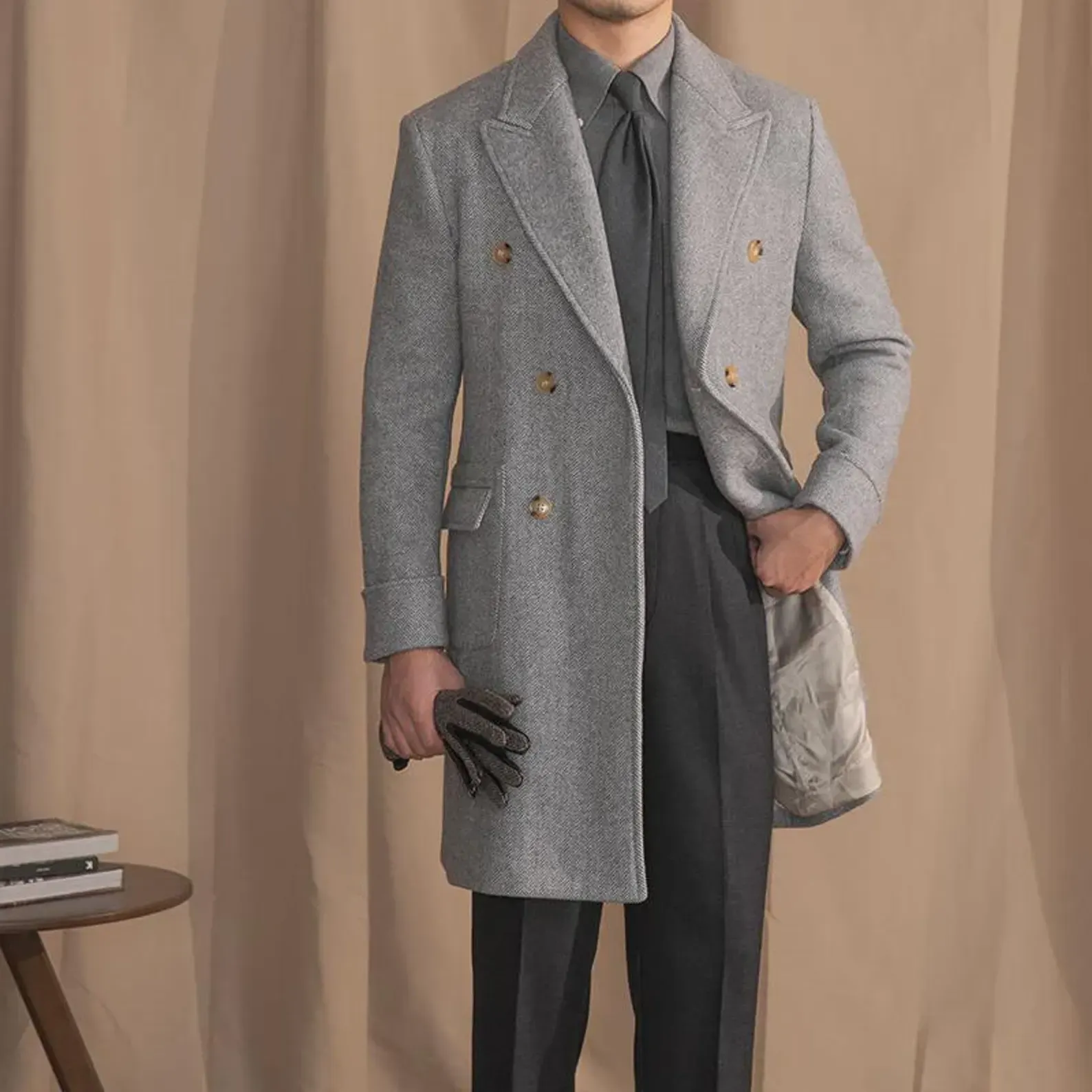 Men's grey herringbone double-breasted overcoat, worn over a suit