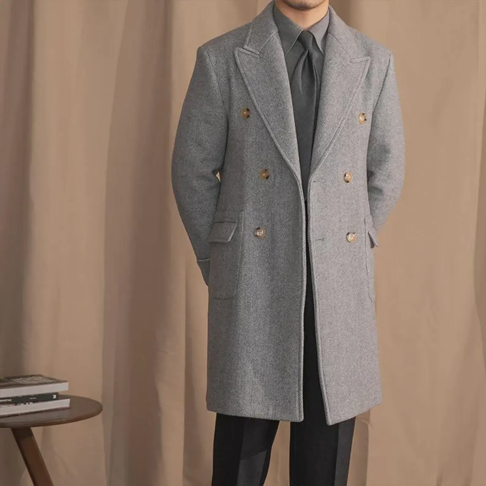 Men's grey herringbone double-breasted overcoat, worn over a suit