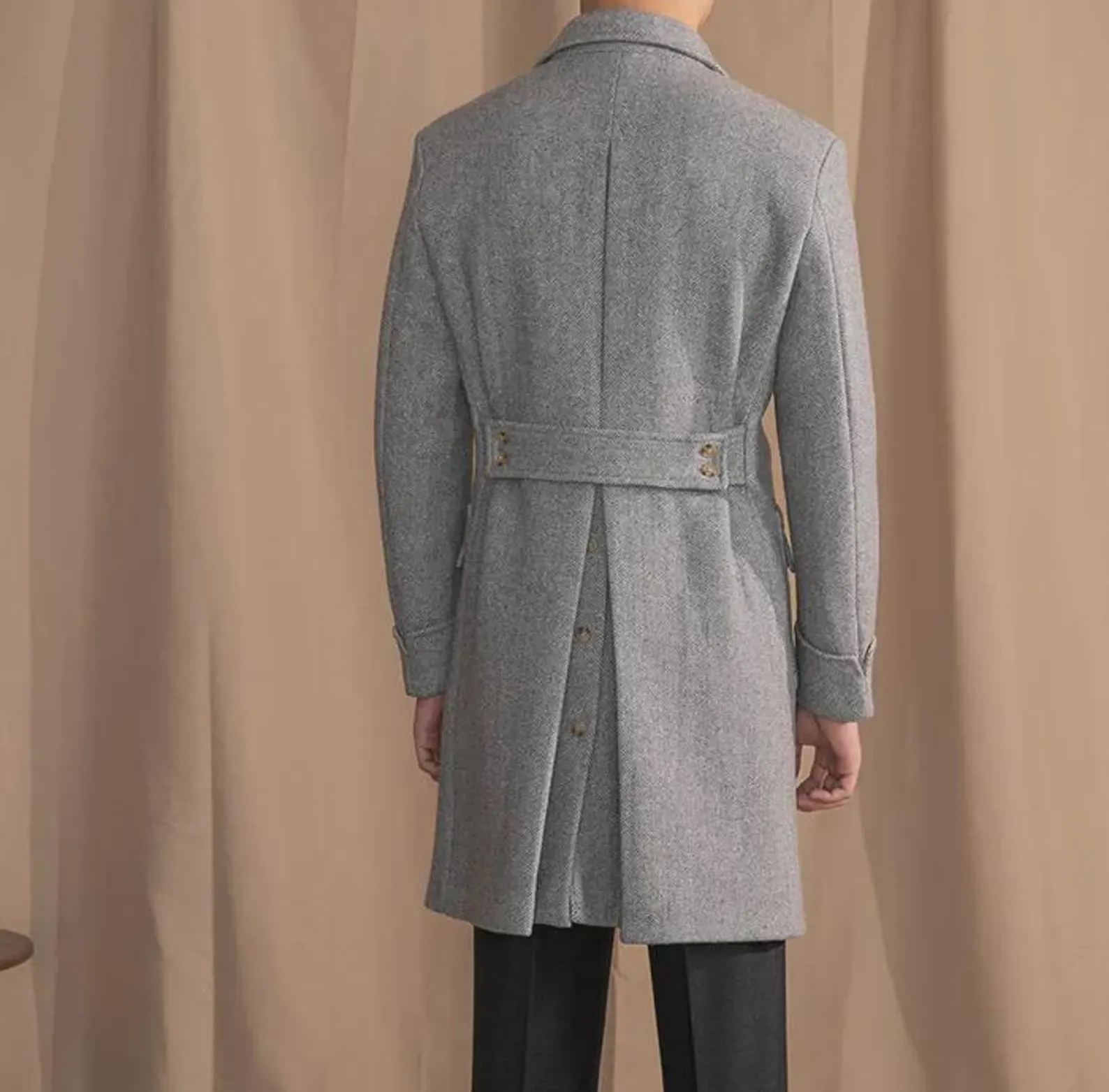 Men's grey herringbone double-breasted overcoat, worn over a suit